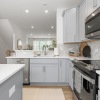 Kitchen with gray cabinets and quartz counters